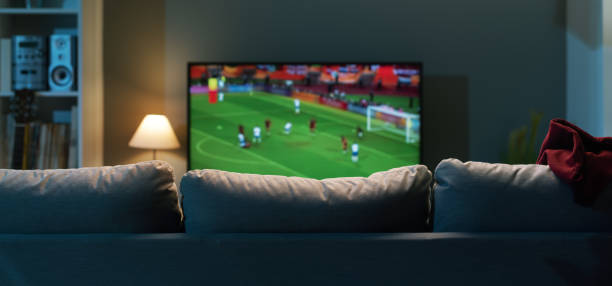 Football match on widescreen flat TV at home, sport and entertainment concept